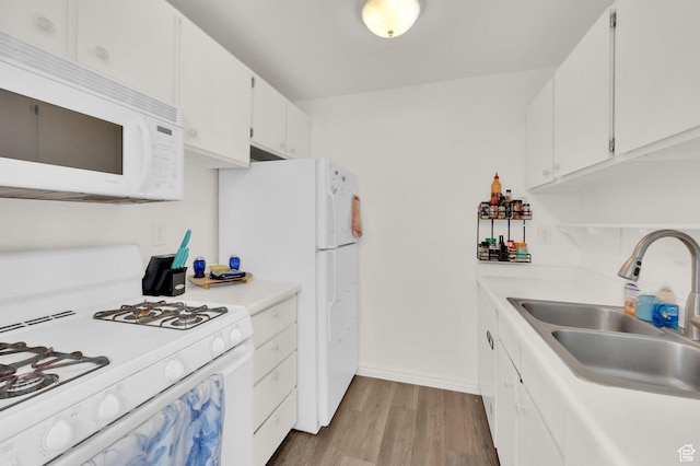 5420 Willow Ln Unit F, Murray, UT 84107 - kitchen featuring white appliances, a sink, wood finished floors, white cabinetry, and light countertops