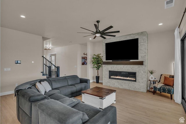 2725 E Ashwood Ln, St George, UT 84790 - living area featuring a stone fireplace, light wood-type flooring, ceiling fan, stairs, and recessed lighting