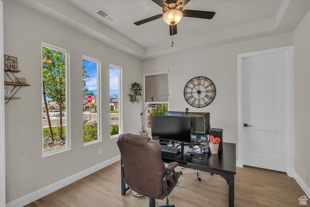 2725 E Ashwood Ln, St George, UT 84790 - home office featuring plenty of natural light, a raised ceiling, ceiling fan, and wood finished floors