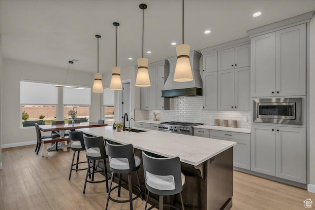 2725 E Ashwood Ln, St George, UT 84790 - kitchen with custom range hood, backsplash, a sink, baseboards, and light wood-style floors
