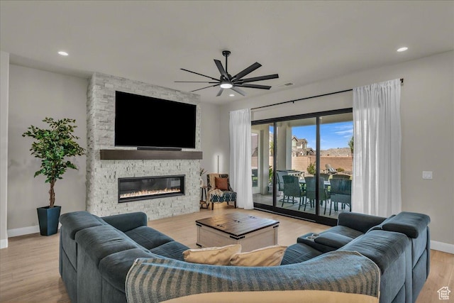 2725 E Ashwood Ln, St George, UT 84790 - living area with ceiling fan, baseboards, a stone fireplace, wood finished floors, and recessed lighting