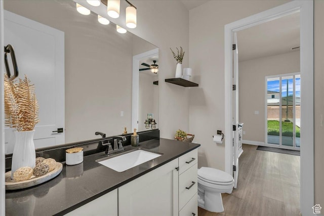 2725 E Ashwood Ln, St George, UT 84790 - bathroom with vanity, toilet, wood finished floors, and baseboards