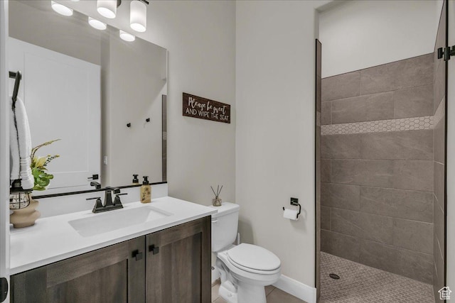 2725 E Ashwood Ln, St George, UT 84790 - full bath featuring toilet, vanity, tiled shower, tile patterned floors, and baseboards