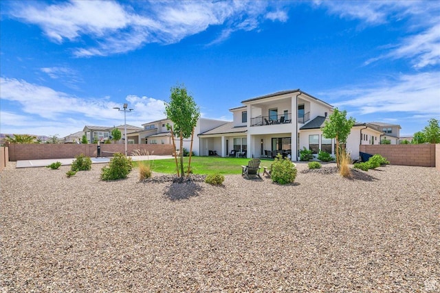 2725 E Ashwood Ln, St George, UT 84790 - rear view of house featuring a balcony, a fenced backyard, stucco siding, and a patio area