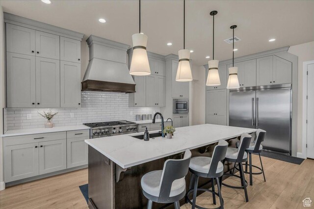 2725 E Ashwood Ln, St George, UT 84790 - kitchen with built in appliances, custom range hood, a sink, light wood-style floors, and recessed lighting
