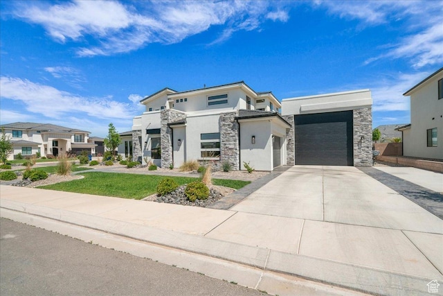 2725 E Ashwood Ln, St George, UT 84790 - modern home featuring stone siding, stucco siding, driveway, and a residential view