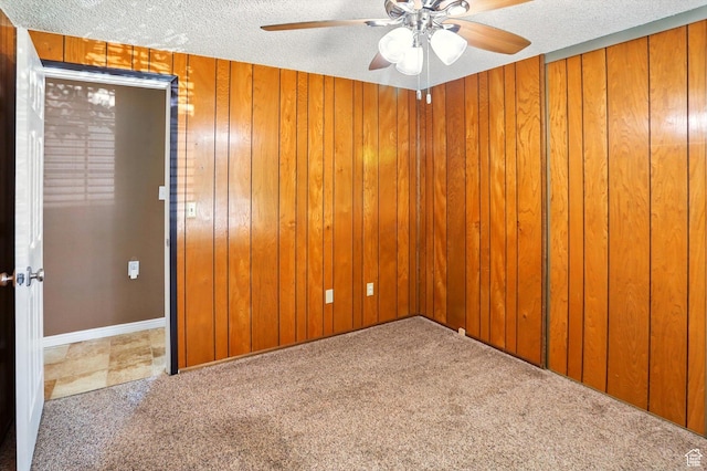 2226 W 1000 N, Tremonton, UT 84337 - unfurnished room with ceiling fan, carpet flooring, a textured ceiling, and wooden walls