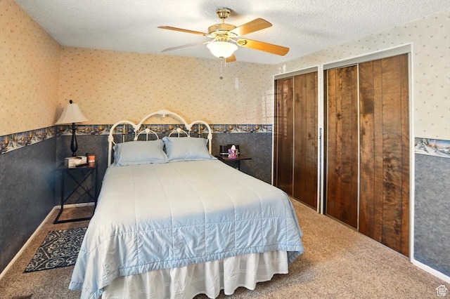 2226 W 1000 N, Tremonton, UT 84337 - carpeted bedroom with wallpapered walls, two closets, a ceiling fan, and a textured ceiling