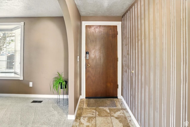 2226 W 1000 N, Tremonton, UT 84337 - doorway to outside with baseboards, a textured ceiling, and arched walkways