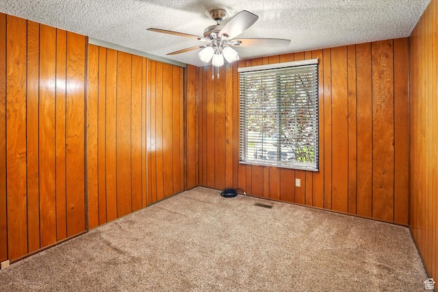 2226 W 1000 N, Tremonton, UT 84337 - empty room with a ceiling fan, a textured ceiling, carpet floors, and wooden walls