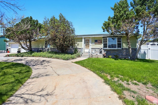 2226 W 1000 N, Tremonton, UT 84337 - view of front of house featuring stone siding, driveway, and a garage