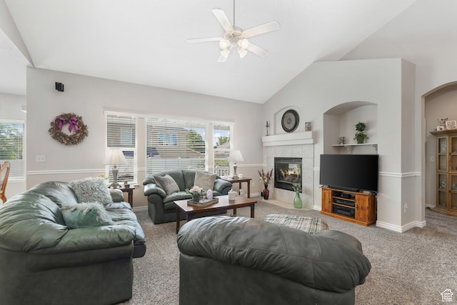 1169 W Bateman Dr, West Jordan, UT 84084 - living area with a ceiling fan, healthy amount of natural light, a tiled fireplace, carpet flooring, and high vaulted ceiling