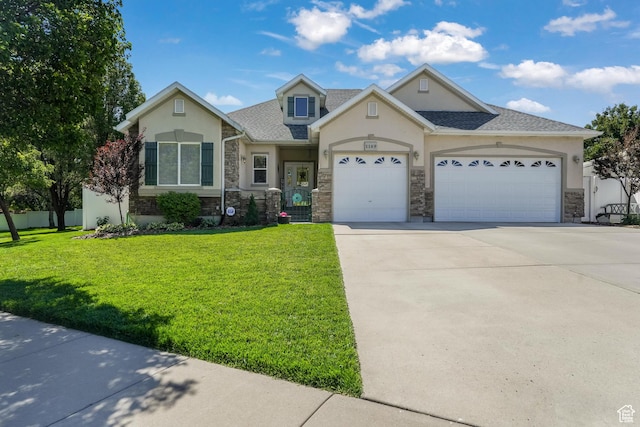 1169 W Bateman Dr, West Jordan, UT 84084 - view of front facade featuring stone siding, stucco siding, driveway, a garage, and a front lawn