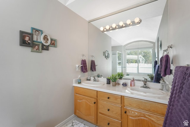 1169 W Bateman Dr, West Jordan, UT 84084 - bathroom with double vanity, vaulted ceiling, and baseboards