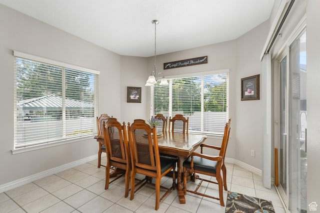 1169 W Bateman Dr, West Jordan, UT 84084 - dining area featuring healthy amount of natural light, a chandelier, light tile patterned floors, and baseboards
