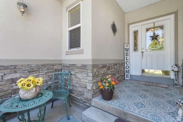 1169 W Bateman Dr, West Jordan, UT 84084 - entrance to property featuring stone siding, stucco siding, and covered porch