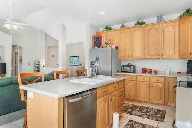 1169 W Bateman Dr, West Jordan, UT 84084 - kitchen featuring stainless steel appliances, a sink, light tile patterned flooring, a ceiling fan, and light countertops