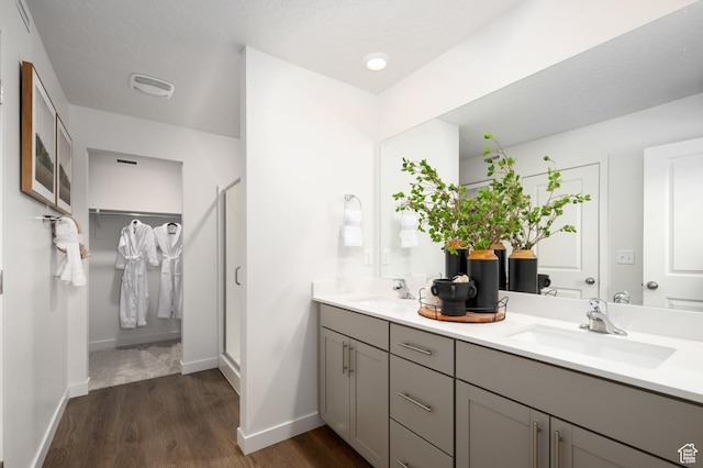 2476 N Wildwood Ln E Unit 249, Heber City, UT 84032 - bathroom with double vanity, wood finished floors, and baseboards