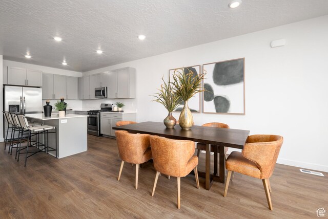 2476 N Wildwood Ln E Unit 249, Heber City, UT 84032 - dining space with dark wood finished floors, recessed lighting, a textured ceiling, and baseboards