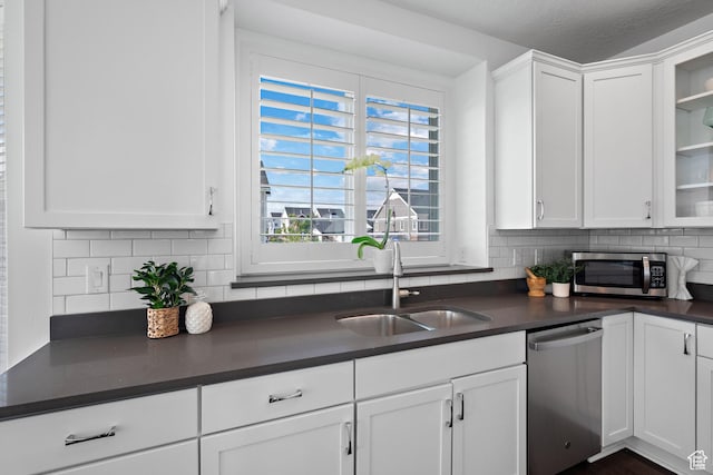 296 E 12025th St S, Draper, UT 84020 - kitchen featuring appliances with stainless steel finishes, dark countertops, tasteful backsplash, and white cabinetry