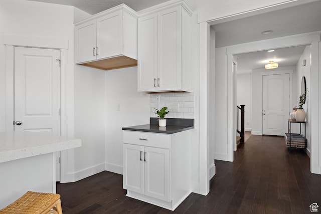 296 E 12025th St S, Draper, UT 84020 - kitchen with dark wood-style flooring, baseboards, white cabinetry, and backsplash