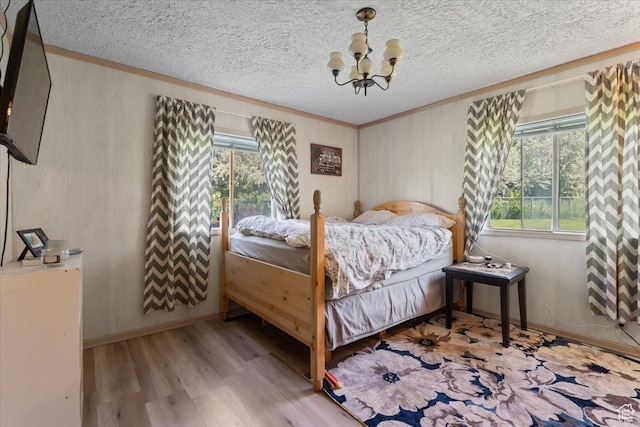 12525 S 1300 E, Draper, UT 84020 - bedroom with a chandelier, wood finished floors, ornamental molding, wooden walls, and baseboards