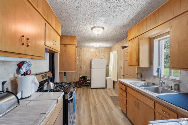 12525 S 1300 E, Draper, UT 84020 - kitchen with freestanding refrigerator, stainless steel gas stove, tile countertops, a sink, and backsplash