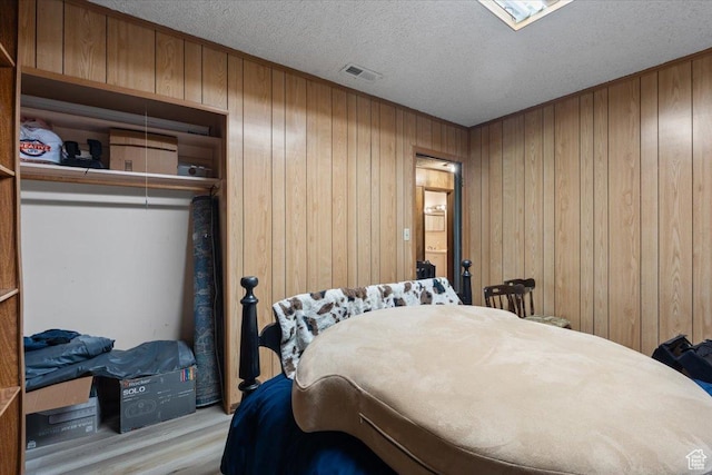 12525 S 1300 E, Draper, UT 84020 - bedroom with wood walls, a textured ceiling, and wood finished floors