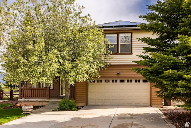 1189 E Fox Crest Dr, Park City, UT 84098 - obstructed view of property with a garage, driveway, roof mounted solar panels, and covered porch