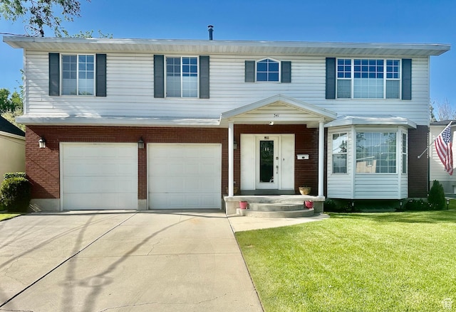 341 E Wilford Ave, Murray, UT 84107 - view of front of home featuring driveway, a front lawn, an attached garage, and brick siding