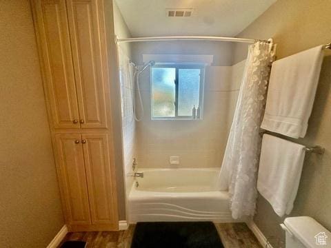 341 E Wilford Ave, Murray, UT 84107 - full bathroom with shower / tub combo with curtain, toilet, baseboards, and wood finished floors
