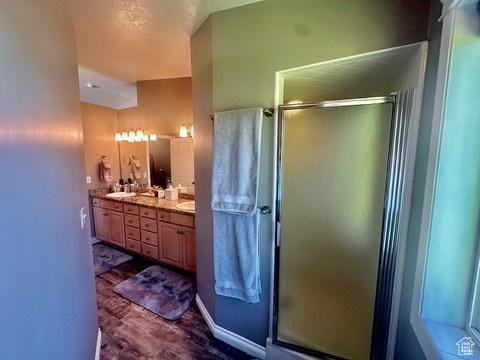 341 E Wilford Ave, Murray, UT 84107 - full bathroom with double vanity, a shower stall, and wood finished floors