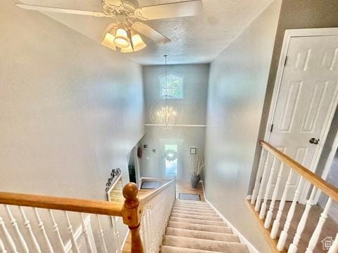 341 E Wilford Ave, Murray, UT 84107 - staircase featuring a ceiling fan, baseboards, and a high ceiling