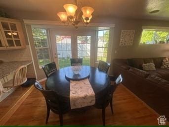 341 E Wilford Ave, Murray, UT 84107 - dining area featuring a chandelier and wood finished floors
