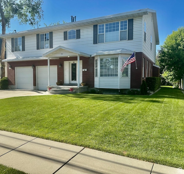 341 E Wilford Ave, Murray, UT 84107 - view of front of home with a garage, brick siding, driveway, and a front yard