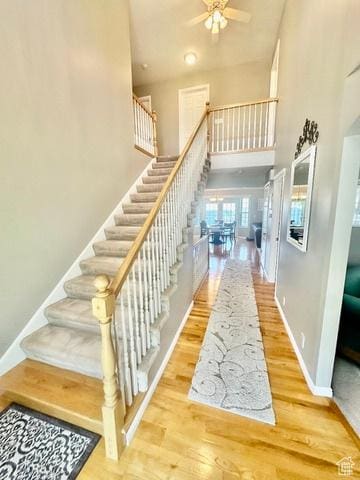 341 E Wilford Ave, Murray, UT 84107 - stairway featuring a high ceiling, wood finished floors, ceiling fan, and baseboards