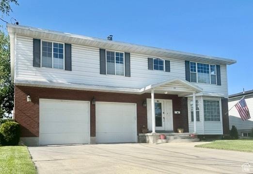 341 E Wilford Ave, Murray, UT 84107 - traditional home featuring an attached garage and concrete driveway