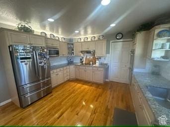 341 E Wilford Ave, Murray, UT 84107 - kitchen with stainless steel appliances, light wood-type flooring, and under cabinet range hood
