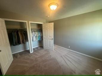 341 E Wilford Ave, Murray, UT 84107 - unfurnished bedroom with multiple closets and baseboards