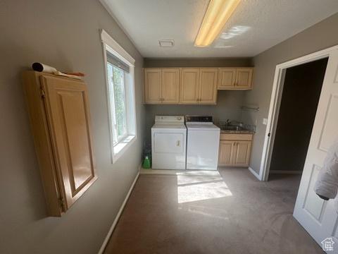 341 E Wilford Ave, Murray, UT 84107 - laundry room featuring washing machine and clothes dryer, cabinet space, baseboards, and light colored carpet