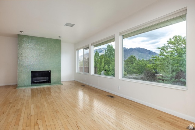 2006 E Creek Rd, Sandy, UT 84093 - unfurnished living room with wood-type flooring, a fireplace, baseboards, and a mountain view