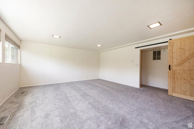 2006 E Creek Rd, Sandy, UT 84093 - carpeted empty room with a barn door and baseboards