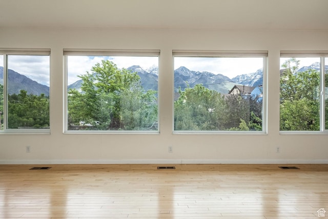 2006 E Creek Rd, Sandy, UT 84093 - spare room featuring wood-type flooring, plenty of natural light, and a mountain view