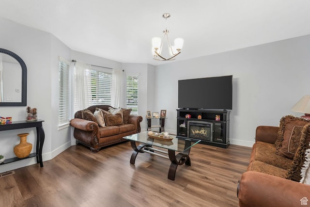 1107 N Independence Ave W, Provo, UT 84604 - living area with a chandelier, wood finished floors, baseboards, and a glass covered fireplace