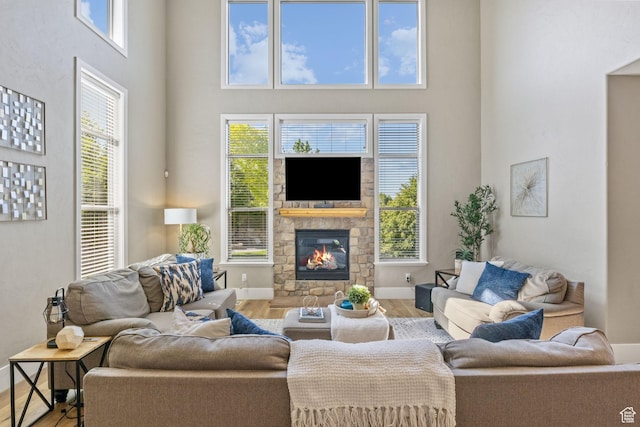 36 E 1450 N, Lehi, UT 84043 - living area with wood finished floors, a high ceiling, a stone fireplace, and baseboards