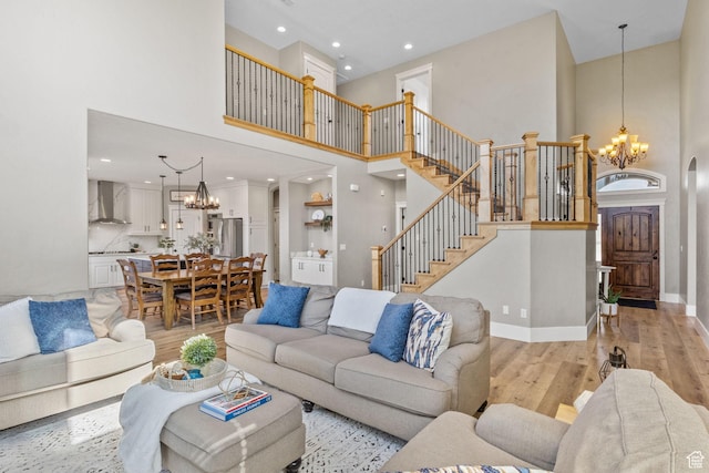 36 E 1450 N, Lehi, UT 84043 - living area with a chandelier, a high ceiling, light wood finished floors, stairway, and baseboards