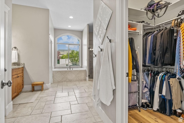 36 E 1450 N, Lehi, UT 84043 - full bathroom with vanity, a bath, baseboards, recessed lighting, and a walk in closet