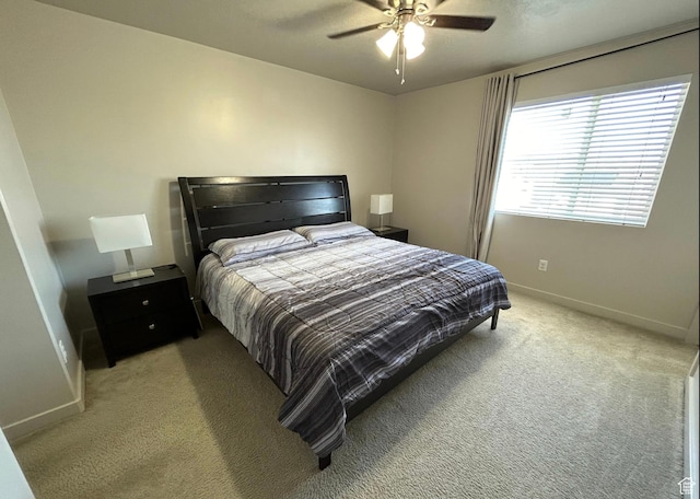 5288 W Solafax Ln Unit 34-1, Herriman, UT 84096 - bedroom featuring light colored carpet, baseboards, and ceiling fan