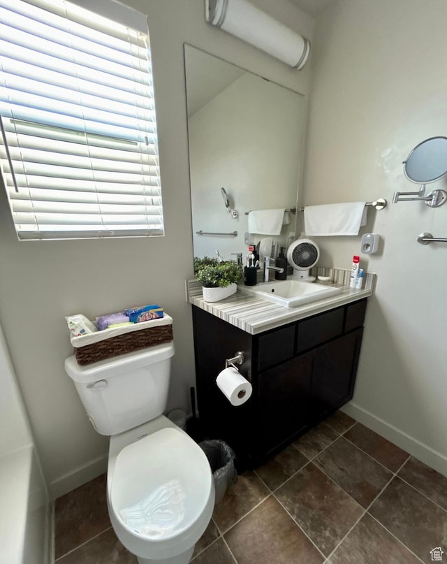 5288 W Solafax Ln Unit 34-1, Herriman, UT 84096 - bathroom featuring vanity, toilet, baseboards, and tile patterned flooring