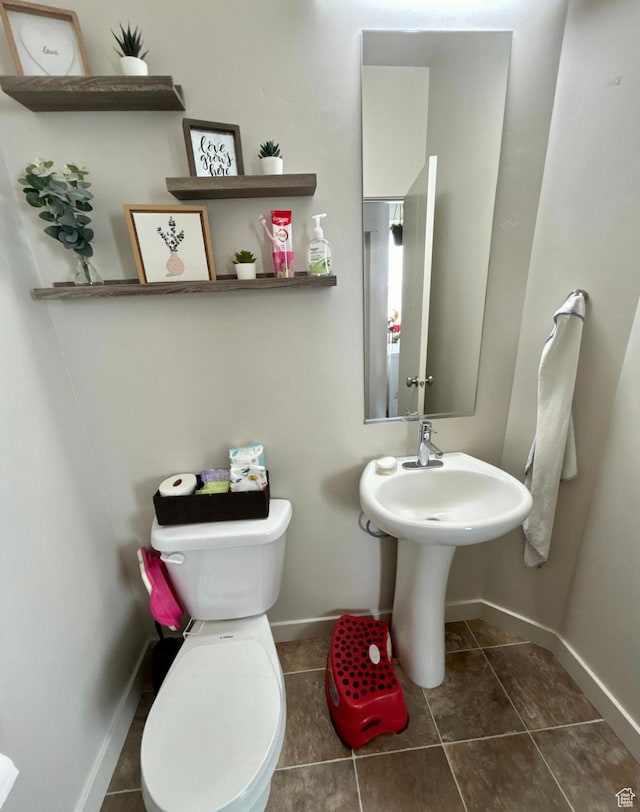 5288 W Solafax Ln Unit 34-1, Herriman, UT 84096 - half bathroom featuring baseboards, toilet, and tile patterned floors